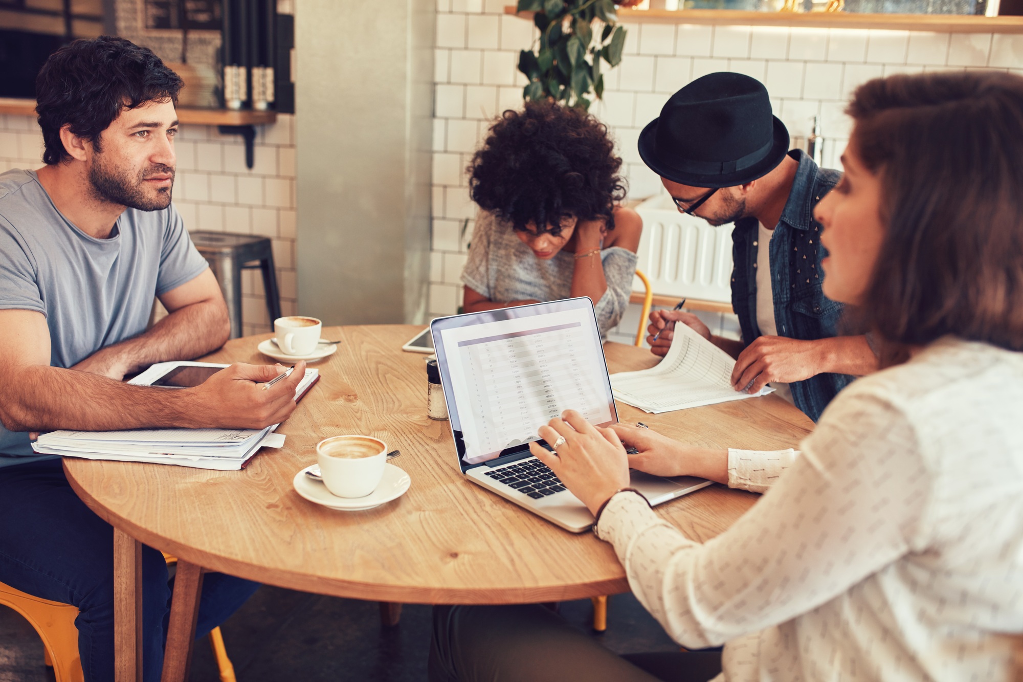 Team of creative people meeting in a cafe